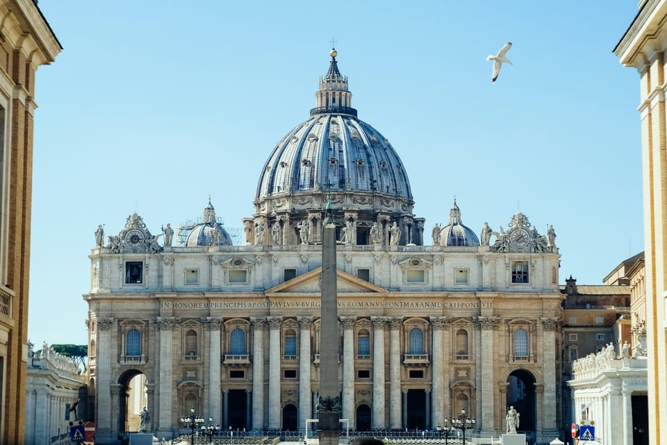 The facade and dome of St. Peter's Basilica, with the obelisk and the colonnade of the square